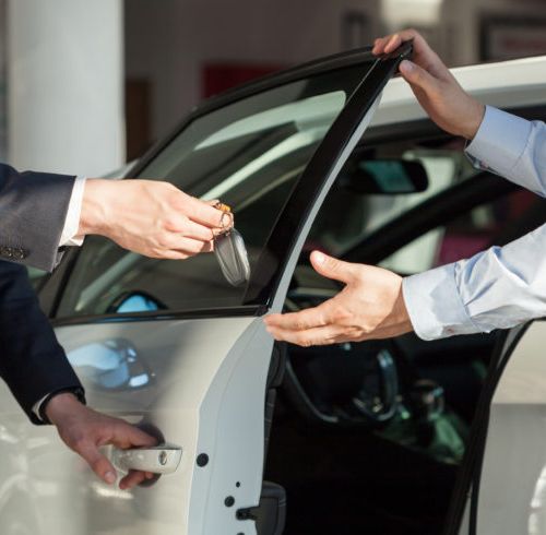 Salesman's hands giving key